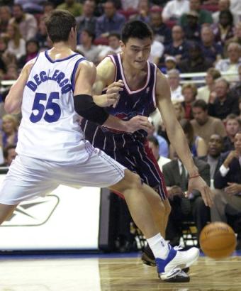 Yao dribbles past Orlando's Andrew DeClercq in the second quarter Wednesday night.  Yao and the Rockets cruised past the Magic 91-81 in their best road performance of the season.