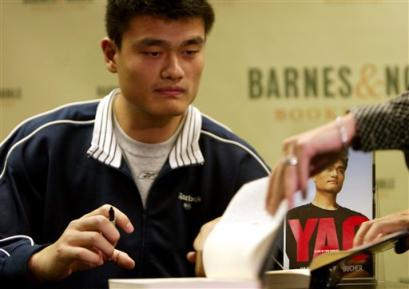 Yao signs copies of his new book at a Barnes & Noble in New York on Tuesday, 9/28/04.